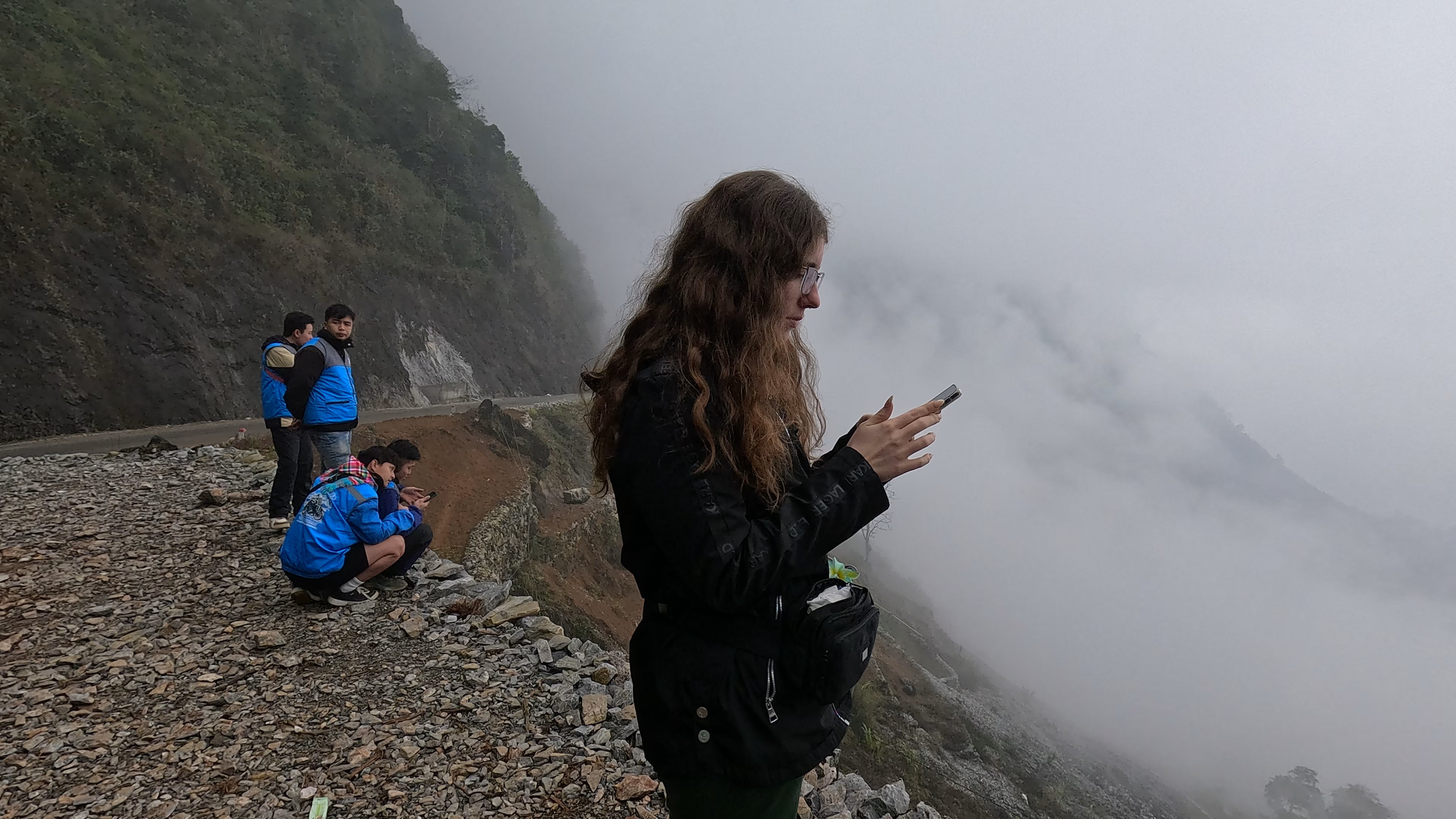 Sarah using mobile data in the mountains of Ha Giang, Vietnam