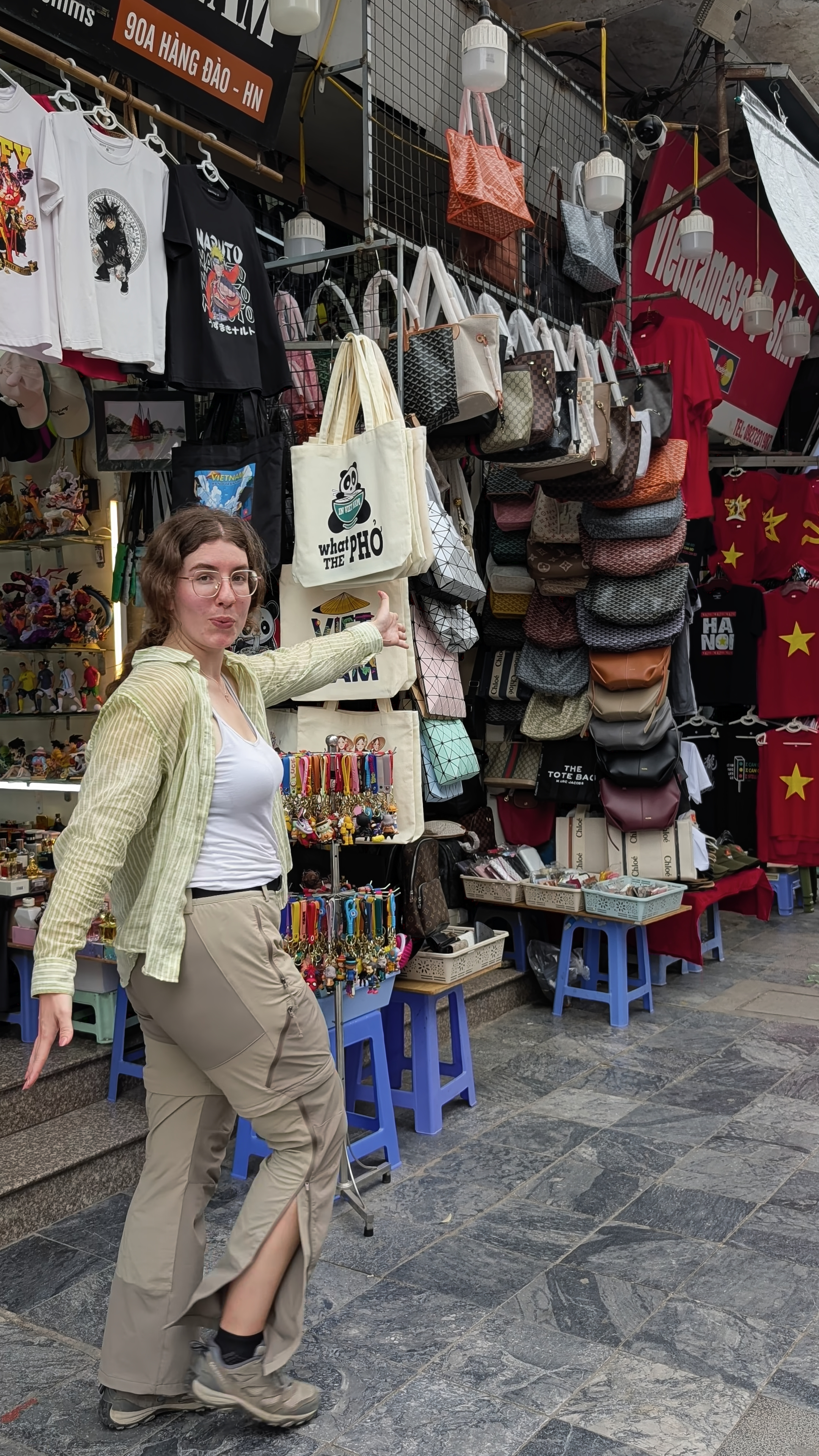 Sarah at Dong Xuan Street in Hanoi, full of shops selling clothes and bags