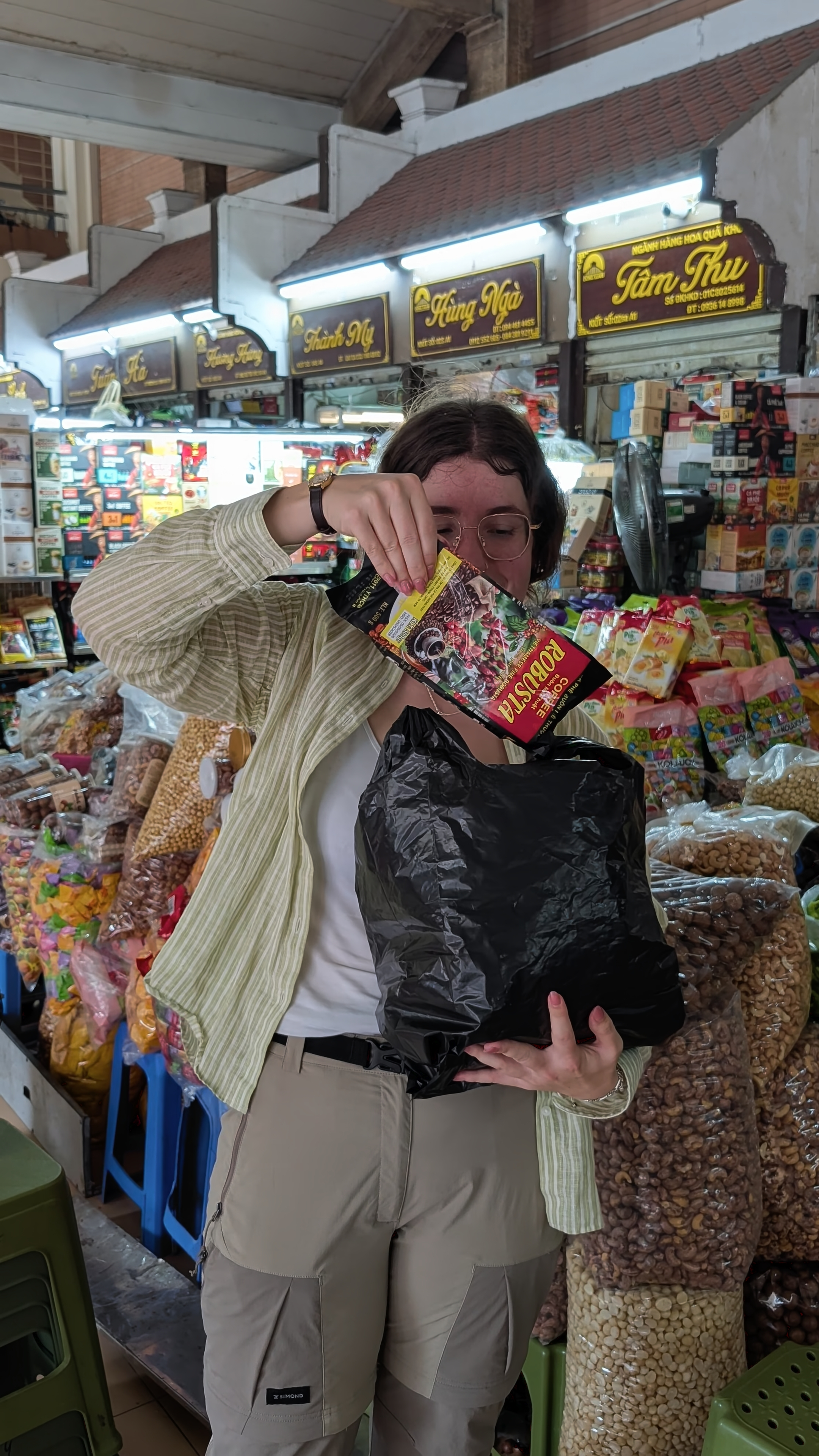 Sarah bulk buying coffee in a market in Hanoi