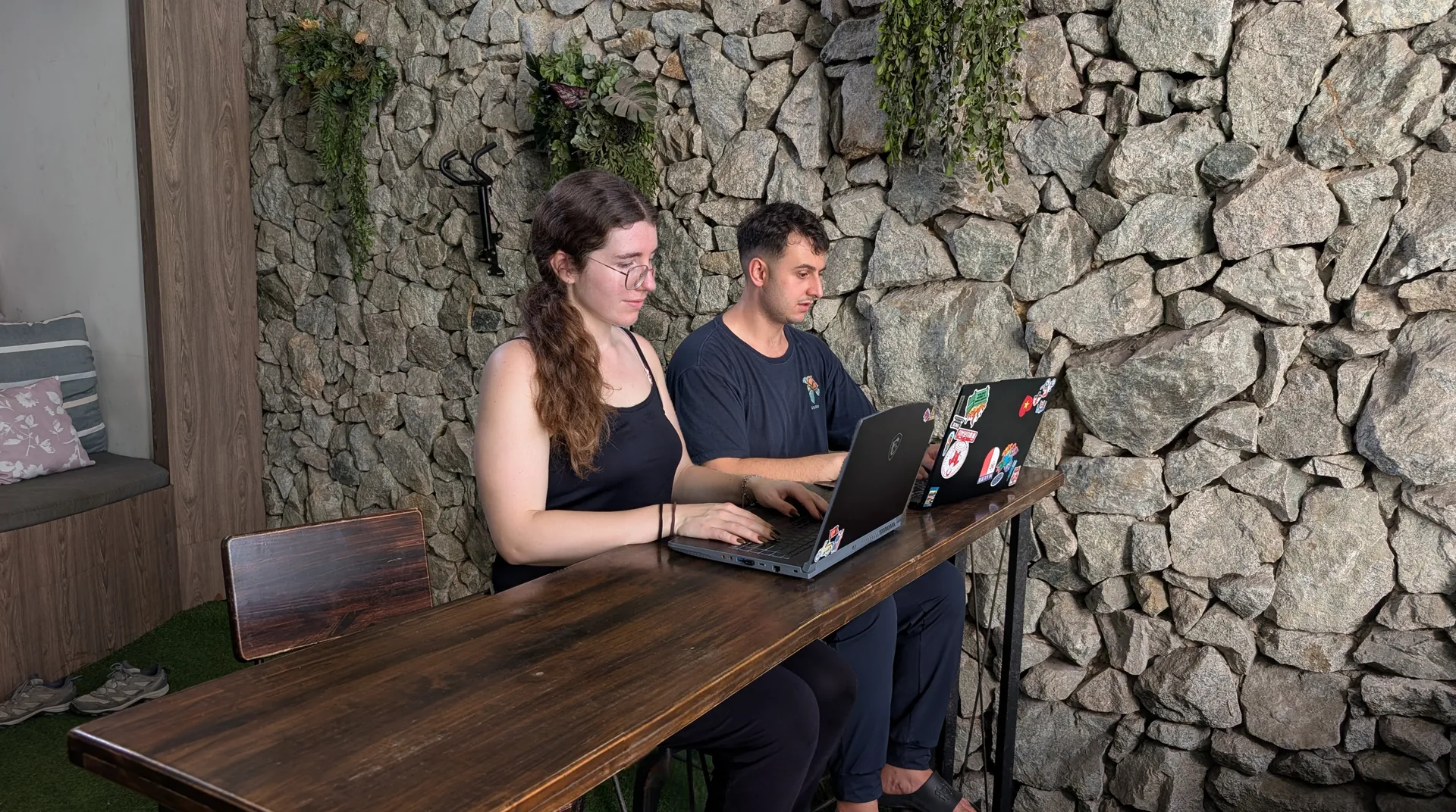 Liam and Sarah working on laptops together, Vietnam, October 2026.