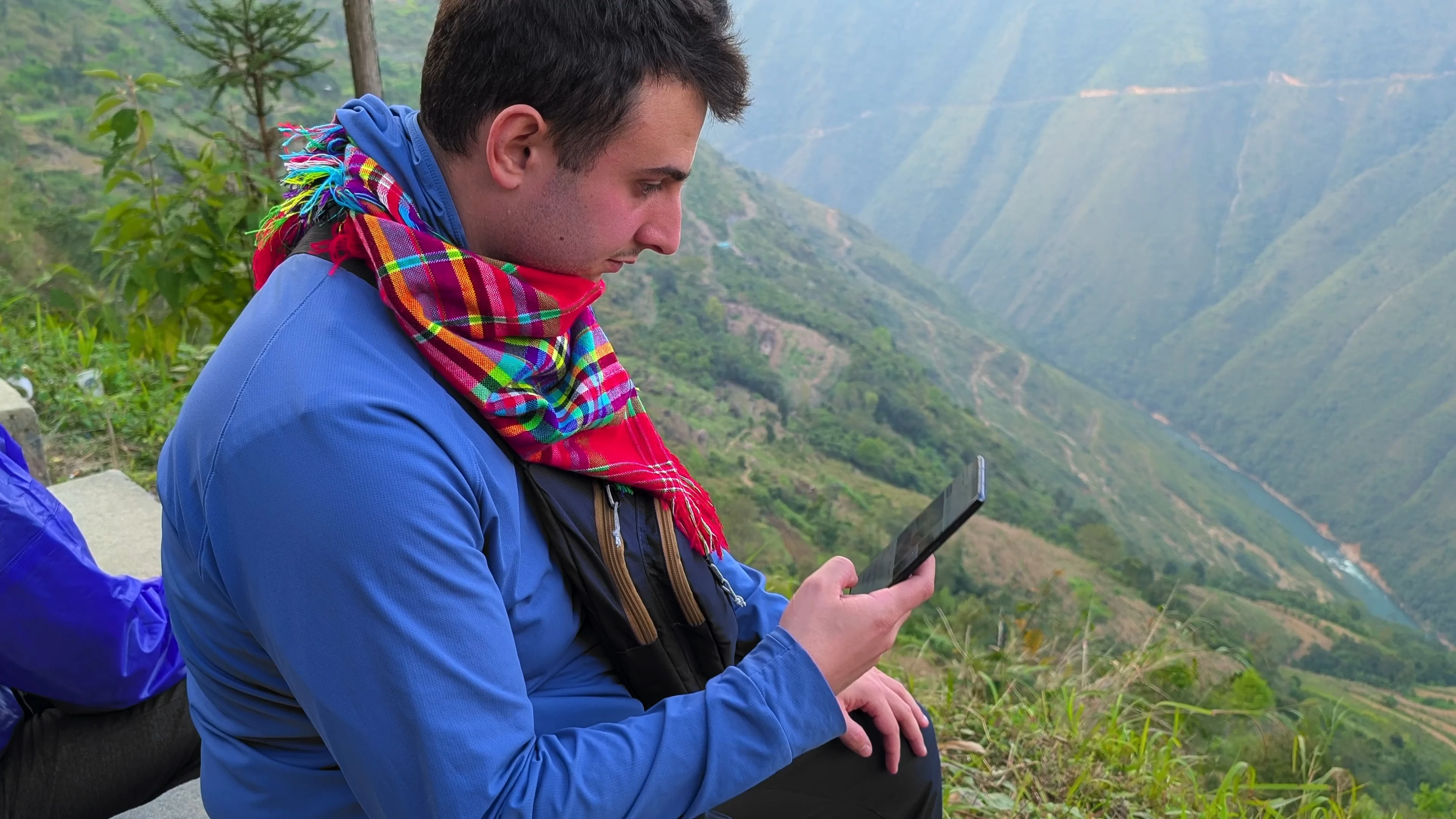 Liam using phone in remote mountains in Vietnam